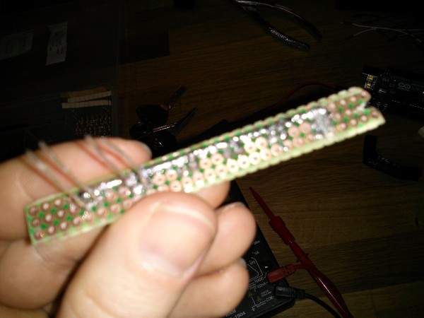 My LED strip. About as good as I can manage on this kind of perfboard. I'm kinda regretting not integrating resistors into this board already. I don't dare try to fix it though -- already burned up two LEDs doing that.